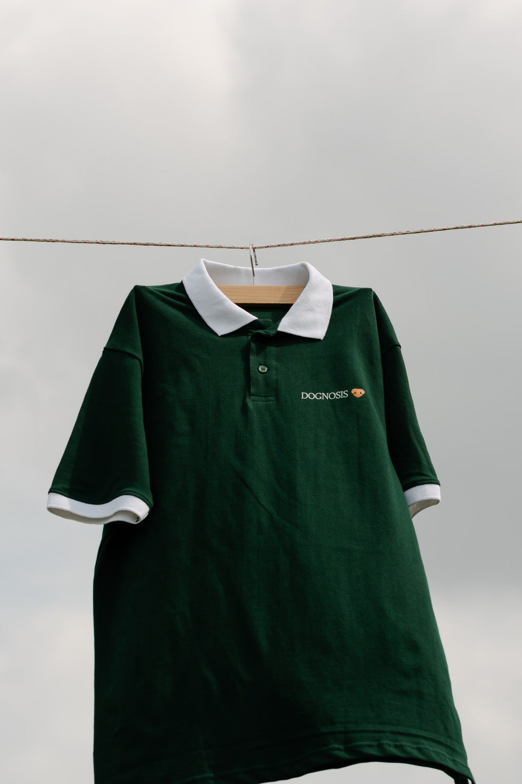 Forest green Dognosis polo shirt with white collar and cuffs